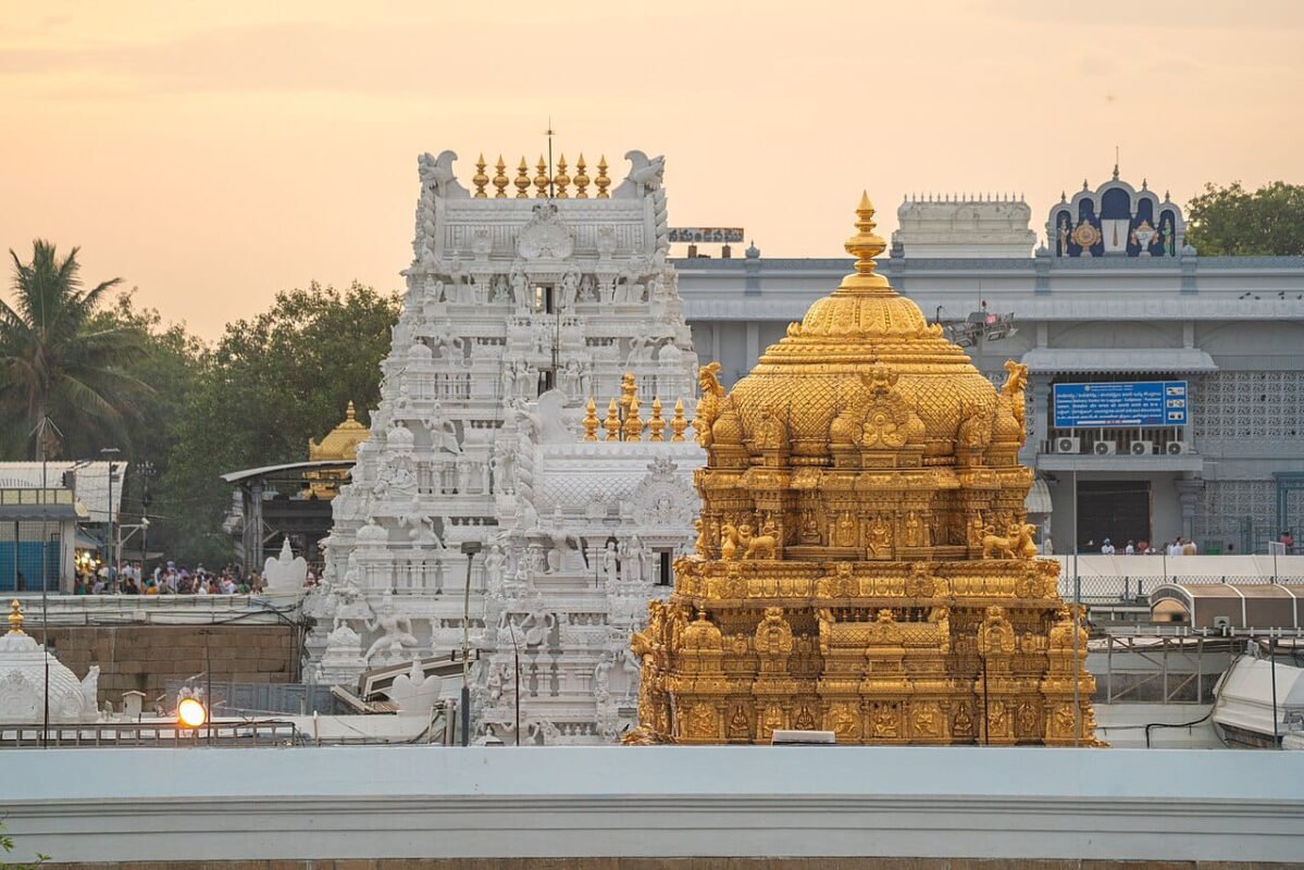 “Golden Vimanam and white gopurams of Tirumala Tirupati Temple at sunrise, showcasing the sacred architecture.”